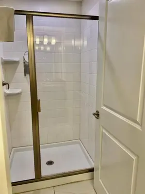 a shower with a glass door in a bathroom at Excellent Resort Free/ Makin Memories / 4 Beds in Kissimmee