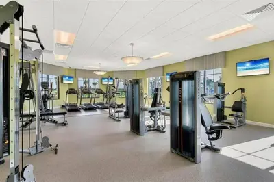 a gym with several treadmills and cardio machines at Excellent Resort Free/ Makin Memories / 4 Beds in Kissimmee