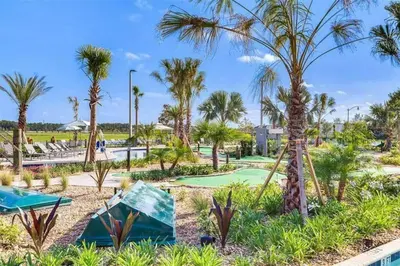 a golf course with palm trees in a resort at Excellent Resort Free/ Makin Memories / 4 Beds in Kissimmee