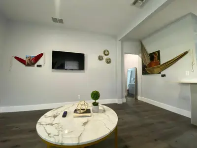 a living room with a marble table and a tv at Bella Breeze in Sanford