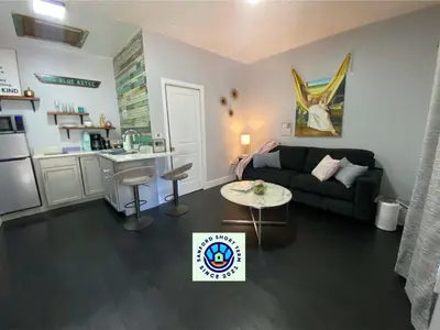 a living room with a couch and a table at The Blue Aztec in Sanford