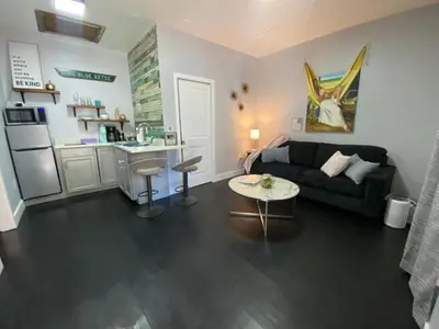 a living room with a couch and a table at The Blue Aztec in Sanford