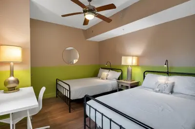 a bedroom with two beds and a ceiling fan at Designer 3BR/2BA Corner Suite - Disney & Universal in Orlando