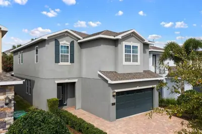 a large gray house with a garage at Luxurious Encore Villa 10 Min Disney Inc/Waterpark in Orlando