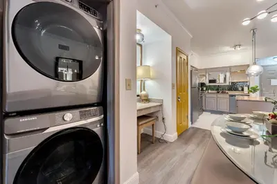 a kitchen with a washing machine and a dining room at Designer Corner Suite 3BR/2BA -Disney & Universal in Orlando