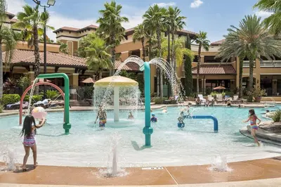 a group of children playing in a pool at a resort at Designer Corner Suite 3BR/2BA -Disney & Universal in Orlando