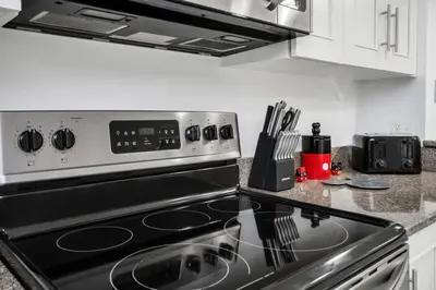 a kitchen with a stove top oven in a kitchen at Newly Renovated Stylish Villa with Star Wars Mickey and Safari Themed Rooms #3TV4706 in Kissimmee