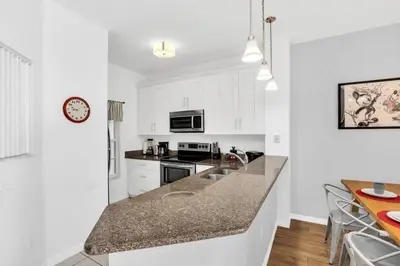 a kitchen with white cabinets and a counter top at Newly Renovated Stylish Villa with Star Wars Mickey and Safari Themed Rooms #3TV4706 in Kissimmee