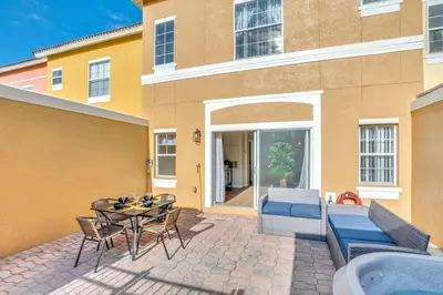 a patio with a table and chairs next to a building at Newly Renovated Stylish Villa with Star Wars Mickey and Safari Themed Rooms #3TV4706 in Kissimmee