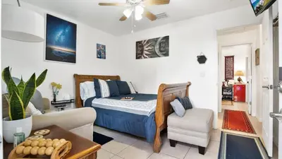 a bedroom with a bed and a living room at La Maison de Lorbu - Apartment in Orlando