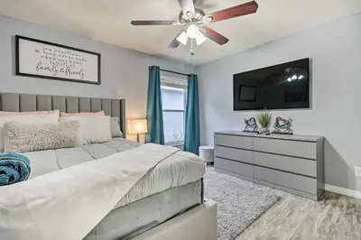 a bedroom with a bed and a ceiling fan at Chic Orlando Family Getaway with Fenced Yard! in Orlando