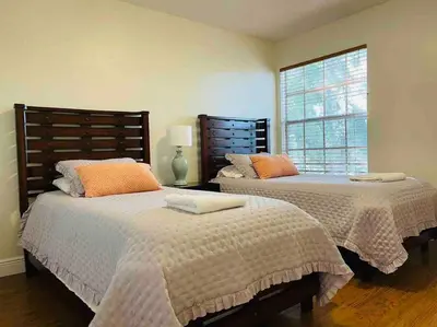 a bedroom with two beds and a window at Luxury • Modern • CLOSE2DISNEY • 3bed • 2bath in Kissimmee