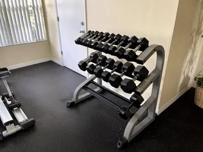a gym with a rack of dumbbells in a room at Luxury • Modern • CLOSE2DISNEY • 3bed • 2bath in Kissimmee