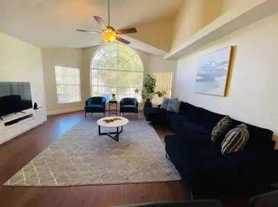 a living room with a couch and a tv at Luxury • Modern • CLOSE2DISNEY • 3bed • 2bath in Kissimmee