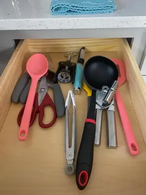 a drawer filled with kitchen utensils on a table at The Contemporary in Sanford