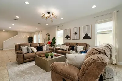 a living room with two couches and a table at Encore Resort 11 Bedroom Home with Pool 2206 in Orlando