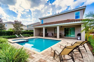 a swimming pool in front of a house at Encore Resort 11 Bedroom Home with Pool 2206 in Orlando