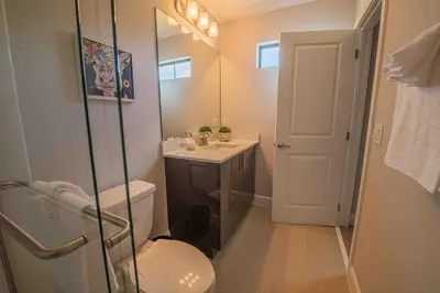 a bathroom with a toilet and a sink and a shower at 3BR Resort Pool Jacuzzi Minutes to Disney 4730 in Kissimmee
