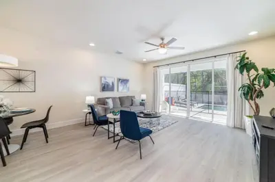 a living room with a couch and a table and chairs at Private Pool Villa Family Retreat Near Disney World in Orlando