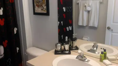 a bathroom with a sink and a mirror at Veteran Owned 3bdr/3 bath Townhouse w/WiFi 3mi to Disney - Fall/Winter Specials in Kissimmee