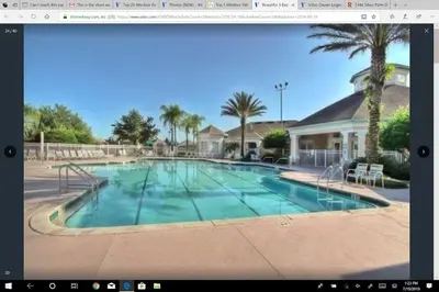 a picture of a swimming pool with palm trees at Veteran Owned 3bdr/3 bath Townhouse w/WiFi 3mi to Disney - Fall/Winter Specials in Kissimmee
