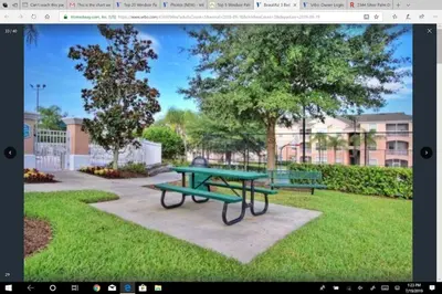 a picnic table in a park with two benches at Veteran Owned 3bdr/3 bath Townhouse w/WiFi 3mi to Disney - Fall/Winter Specials in Kissimmee