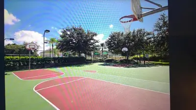 a basketball court with a net and a hoop at Veteran Owned 3bdr/3 bath Townhouse w/WiFi 3mi to Disney - Fall/Winter Specials in Kissimmee