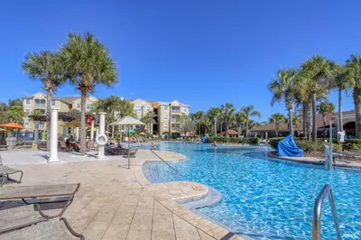 a swimming pool at a resort with palm trees at Windsor Dream - 6 bedroom resort pool home in Orlando
