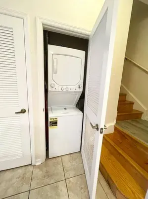 a kitchen with a washer and dryer in a room at Family Friendly 3BR near Disney in Kissimmee
