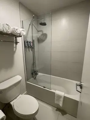 a bathroom with a shower and a toilet and a tub at Newly Room in cozy hotel with Super location to the Parks in Kissimmee