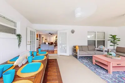 a living room with blue chairs and a couch at Orlando Boho Villa in Kissimmee
