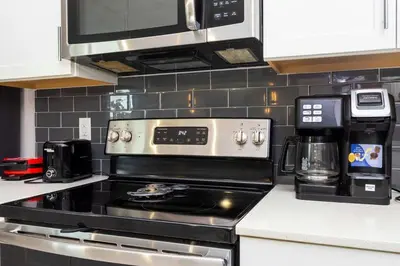 a kitchen with a stove and a microwave at Resort Near Disney FREE Waterpark 4741 in Kissimmee
