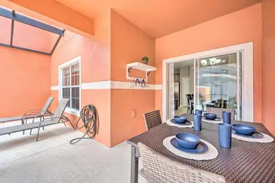 a dining room with a table with blue bowls on it at Private Pool and Lanai Resort Townhome in Kissimmee in Kissimmee