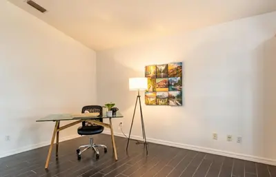 an office with a desk and a lamp in a room at East Orlando Getaway - 3BR/2BTH - *Pool *Parking in Orlando