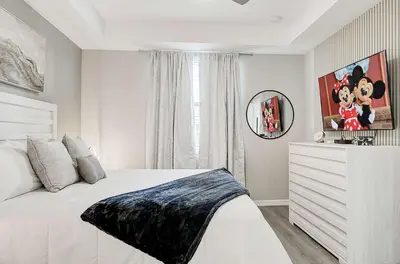 a bedroom with a white bed and a mirror at 4721 Unit 105 BRAND NEW stunning apartment in Kissimmee