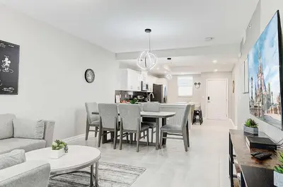 a living room and dining room with a table and chairs at 4721 Unit 105 BRAND NEW stunning apartment in Kissimmee