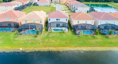 an aerial view of a group of houses and the water at 6BR Resort Villa Near Disney Private Pool 2584 in Kissimmee