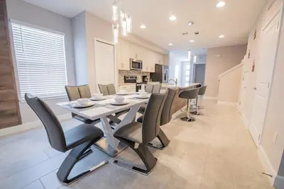 a kitchen and dining room with a table and chairs at Relax water view with Hammock near Disney 4736 in Kissimmee