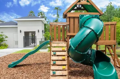 a playground with a slide and a house at Relax water view with Hammock near Disney 4736 in Kissimmee