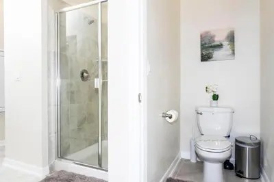 a bathroom with a shower and a toilet at Modern Condo with Lake View Near Disney 3151 in Kissimmee
