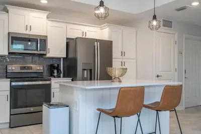 a kitchen with white cabinets and a white counter top at Modern Resort FREE Waterpark Near Disney 3171 in Kissimmee