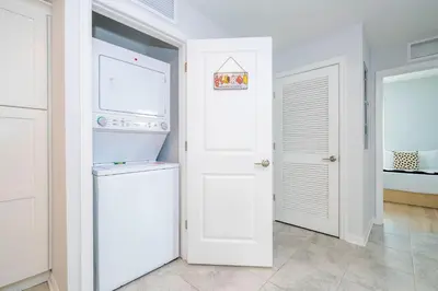 a white laundry room with a washer and dryer at Modern Resort FREE Waterpark Near Disney 3171 in Kissimmee