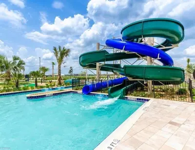 a water slide in a pool at a resort at Resort Condo Near Disney FREE Waterpark 3120 in Kissimmee