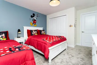 a bedroom with two beds and a red comforter at Special offer near Disney - free waterpark 2857 in Kissimmee