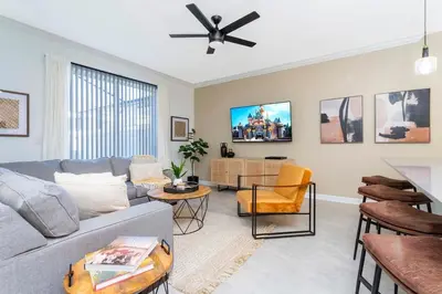 a living room with a couch and a ceiling fan at Modern Clean home Private Pool close Disney 2968 in Kissimmee