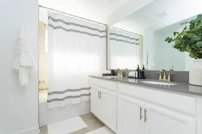 a bathroom with a sink and a mirror at Modern Clean home Private Pool close Disney 2968 in Kissimmee