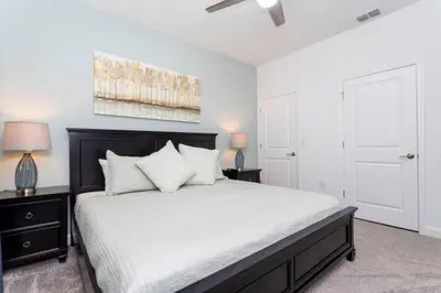 a bedroom with a large bed with white sheets and pillows at FREE Waterpark 4BR Marvel Superhero-Themed 2967 in Kissimmee