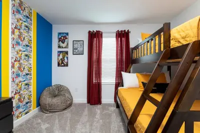 a bedroom with a bunk bed and a ladder at FREE Waterpark 4BR Marvel Superhero-Themed 2967 in Kissimmee