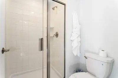 a bathroom with a shower and a toilet at FREE Waterpark 4BR Marvel Superhero-Themed 2967 in Kissimmee