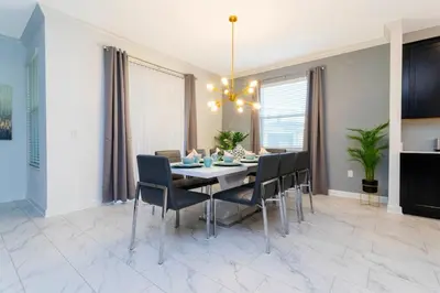a dining room with a table and chairs at Resort-Style Private Pool & Spa Modern 2920 in Kissimmee